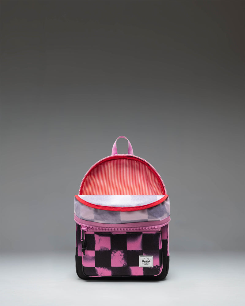Herschel Heritage Kids Backpack in Stencil Checker Opera Mauve, featuring a pink checkered pattern with stencil text details.